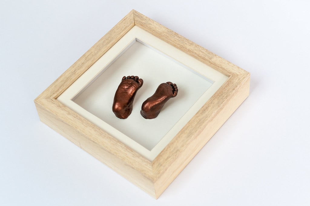 Bronze baby hand casting preserved in elegant frame - 3D casting service