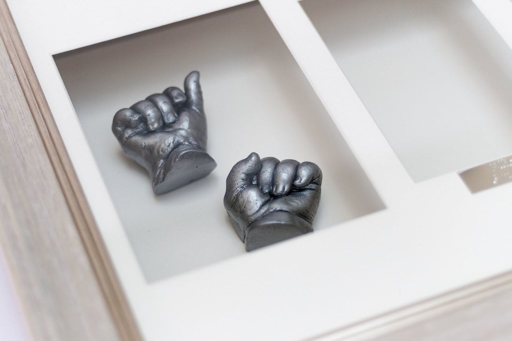 Bronze baby foot casting displayed in beautiful frame - casting specialist