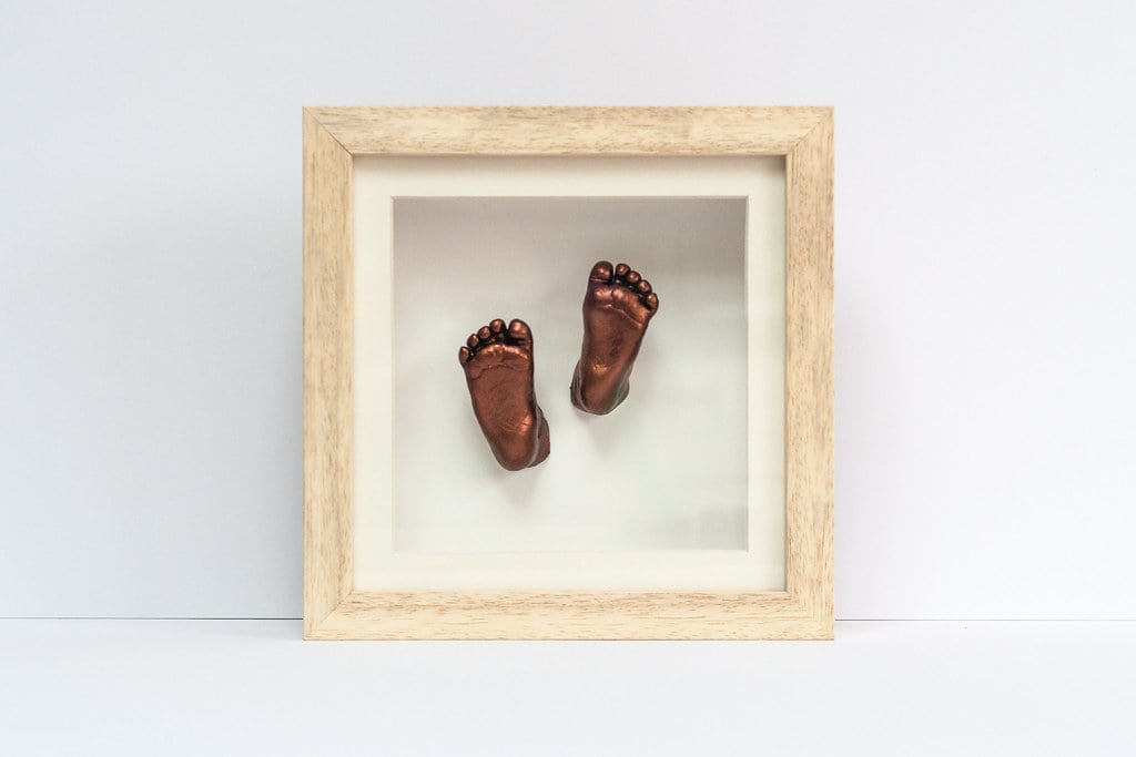 Bronze baby feet casting displayed in beautiful frame - 3D casting service