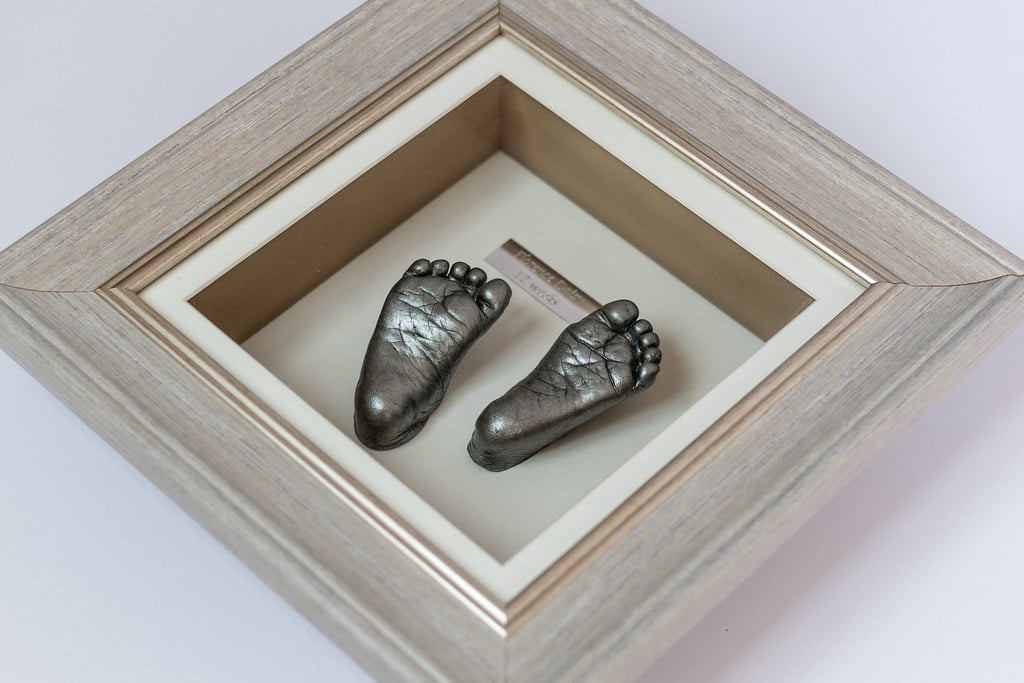 Bronze baby foot casting in 8x10 frame - professional casting service Woking