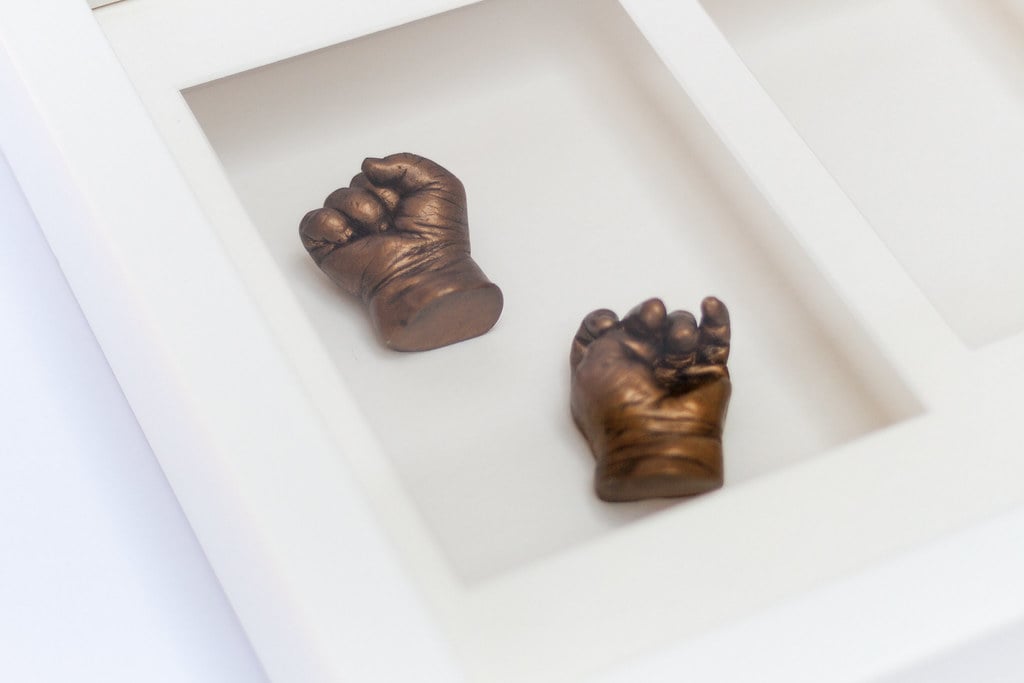 Bronze baby hands casting displayed in 8x10 frame - life casting service