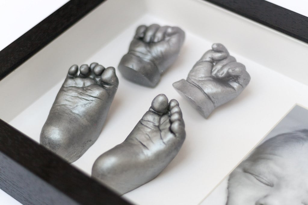 Gold baby hand casting in elegant frame - 3D life casting service