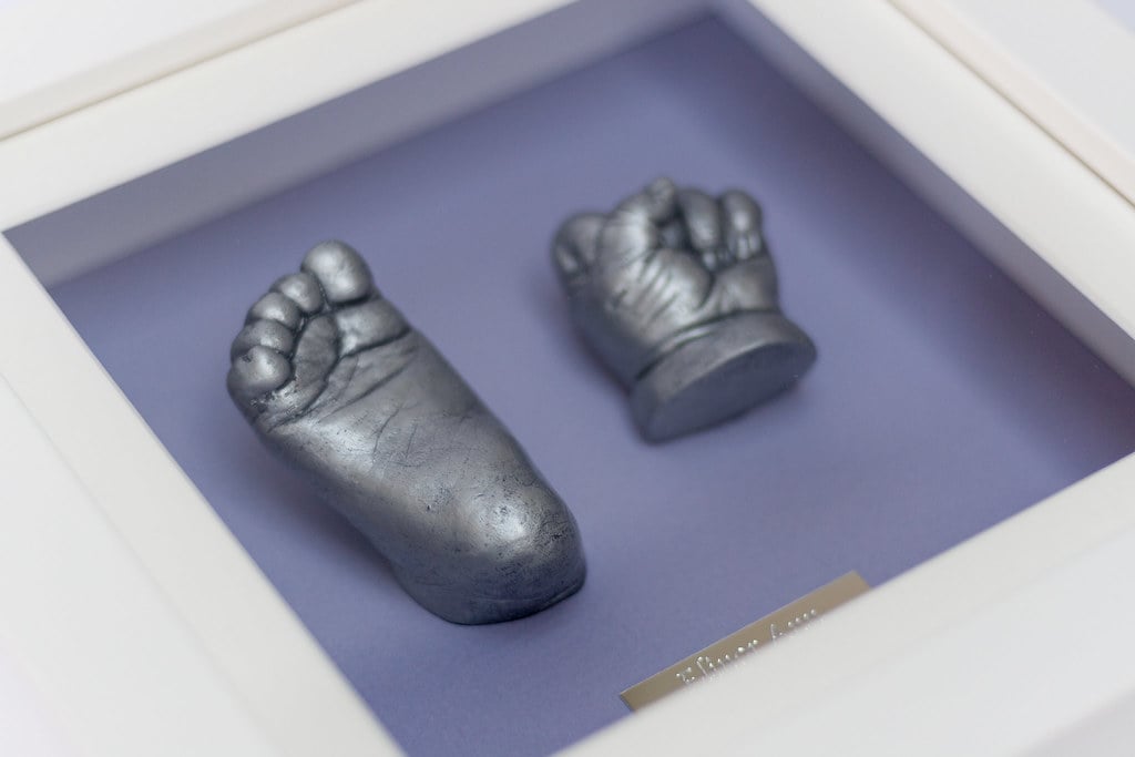 Gold baby foot casting displayed in decorative frame - Casting Impressions