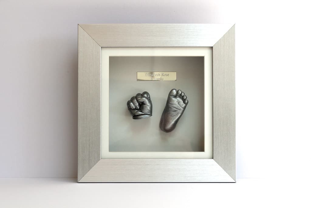 Large framed gold baby hand and foot casting layout